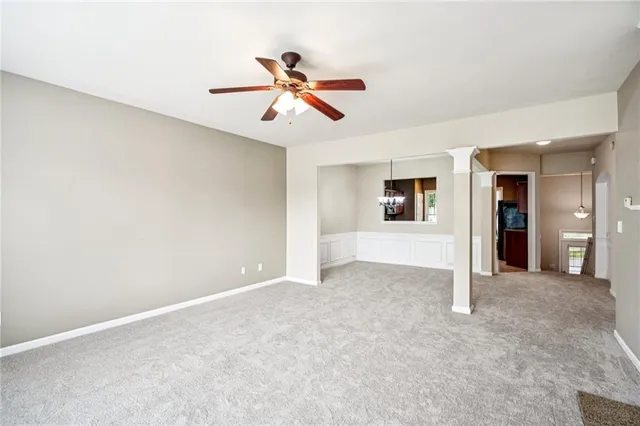 a view of an empty room with window and cabinet