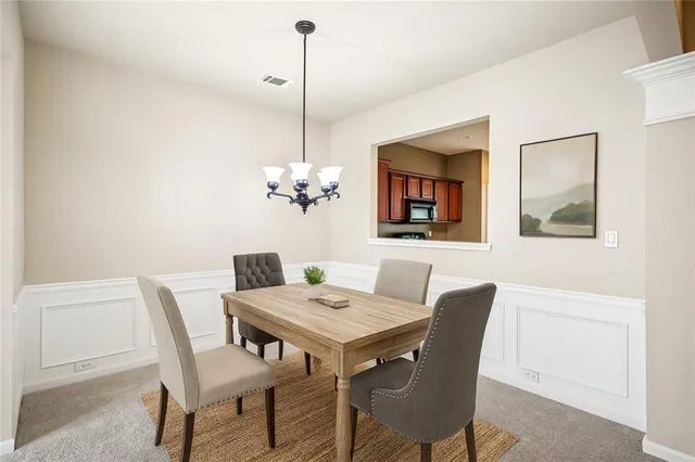 a view of a dining room with furniture wooden floor and a chandelier