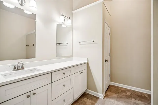 a bathroom with a double vanity sink and mirror