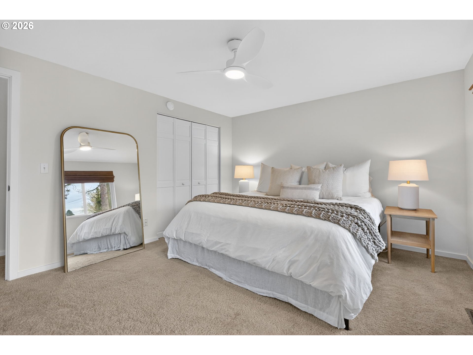 9843 Southwest 2nd Avenue Portland, OR 97219 - Photo 20 of 38 a bedroom with a bed and a mirror