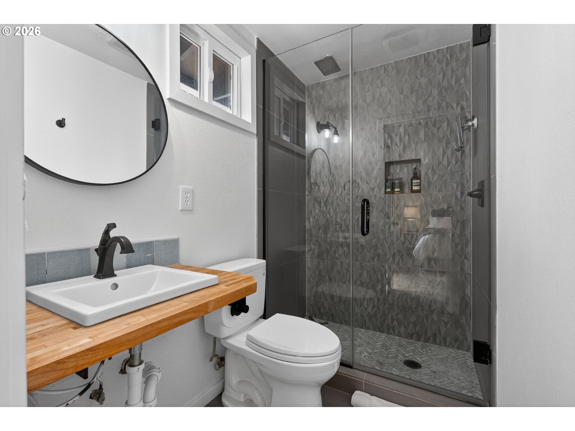 9843 Southwest 2nd Avenue Portland, OR 97219 - Photo 21 of 38 a bathroom with a sink a toilet and shower