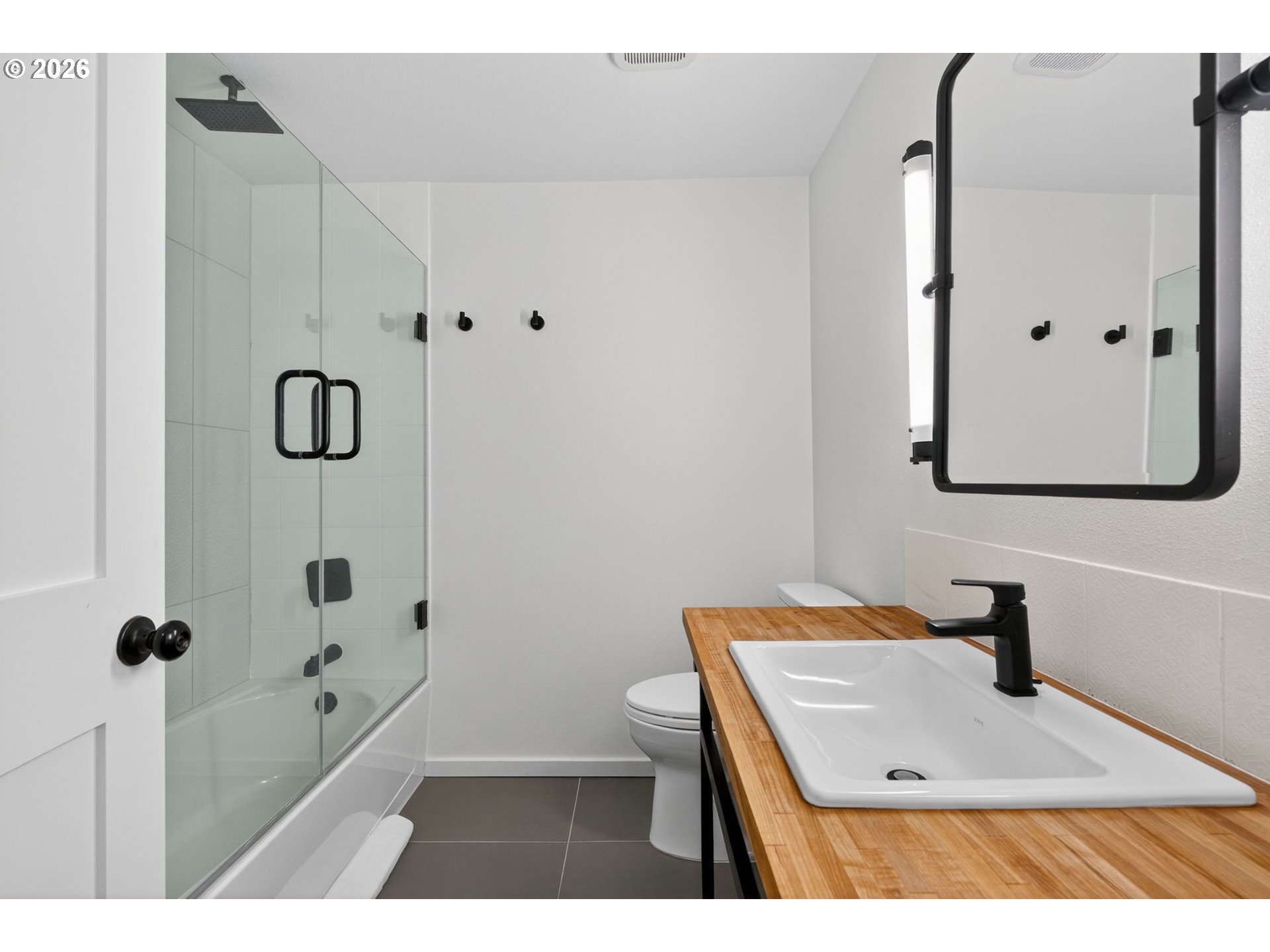 9843 Southwest 2nd Avenue Portland, OR 97219 - Photo 28 of 38 a bathroom with a tub sink and mirror