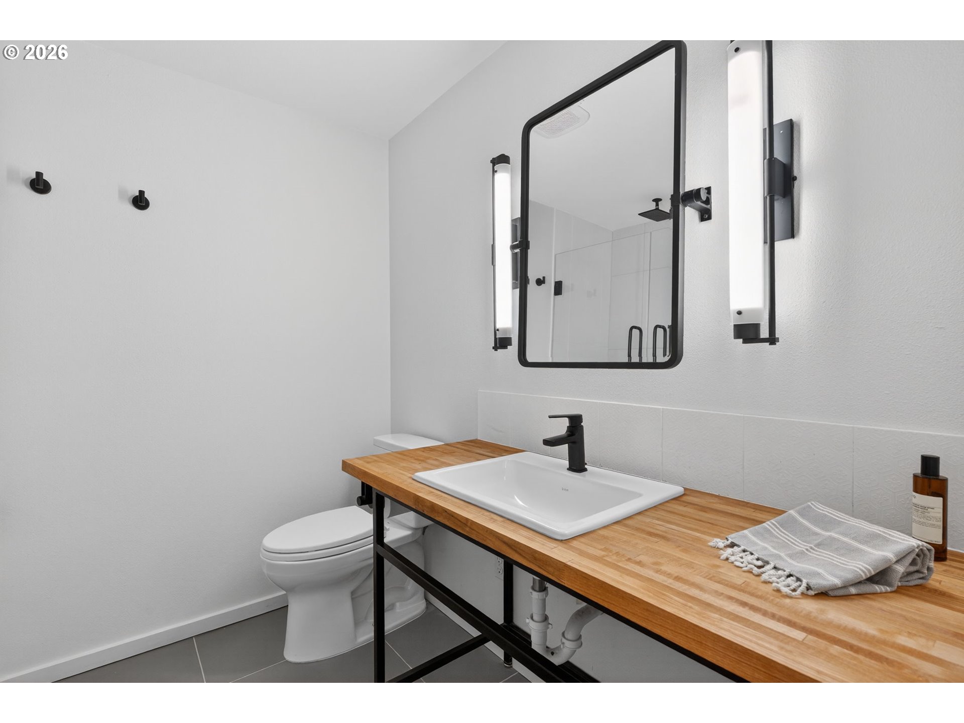 9843 Southwest 2nd Avenue Portland, OR 97219 - Photo 29 of 38 a bathroom with a sink toilet and mirror