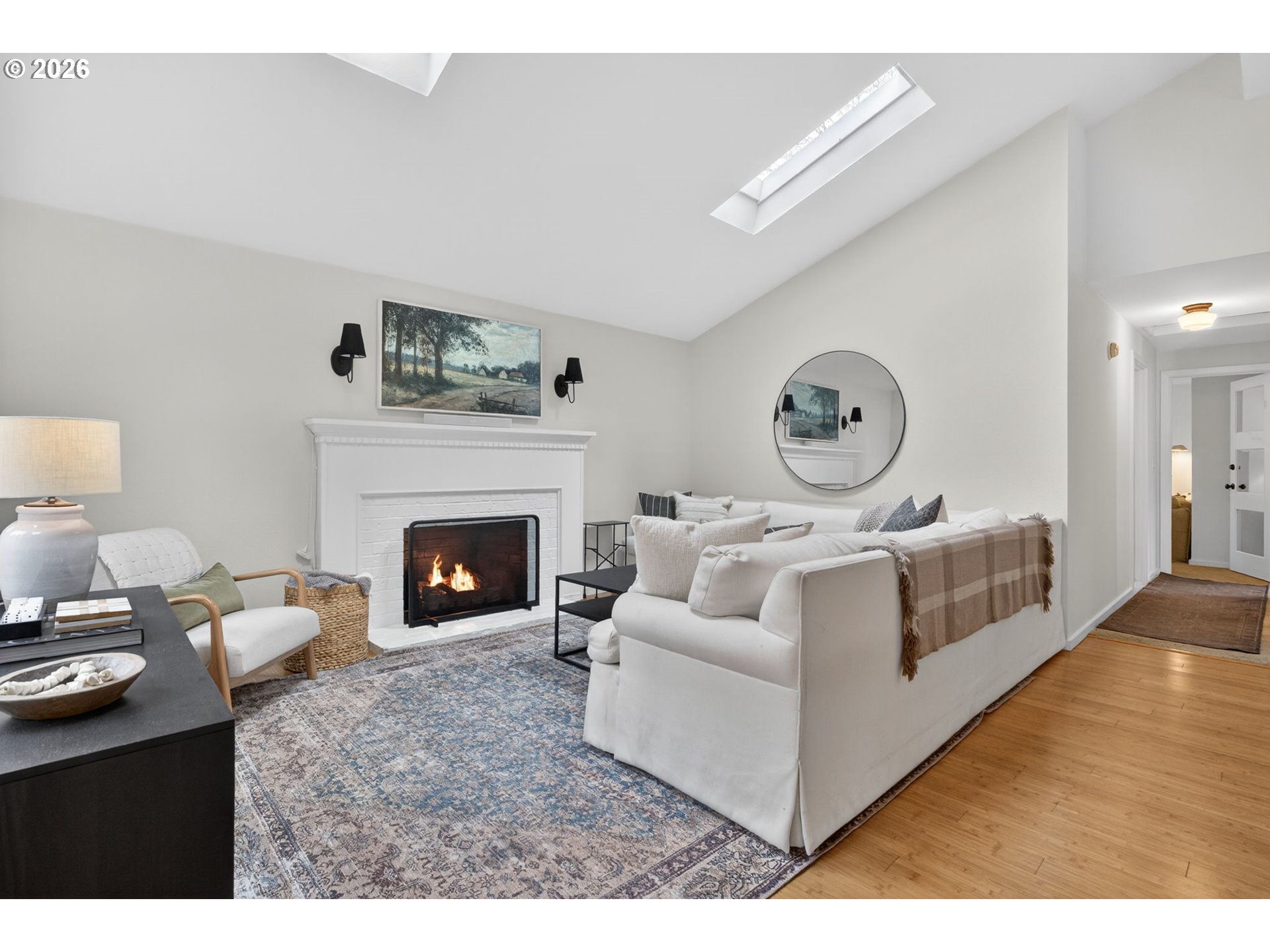 9843 Southwest 2nd Avenue Portland, OR 97219 - Photo 5 of 38 a living room with furniture a clock and a fireplace