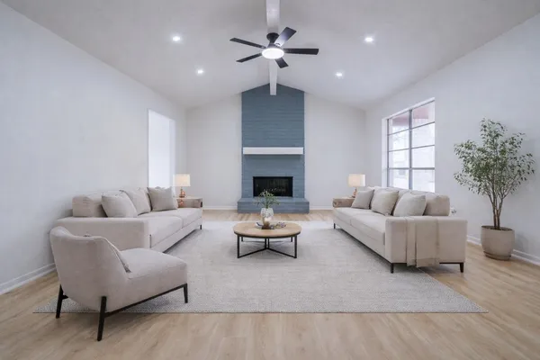 a living room with furniture a chandelier and a fireplace