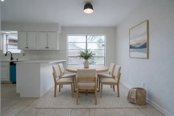 a dining room with furniture and window