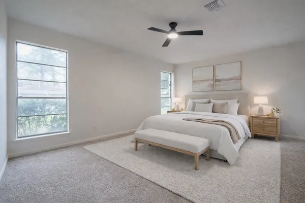 a bedroom with a bed and a window