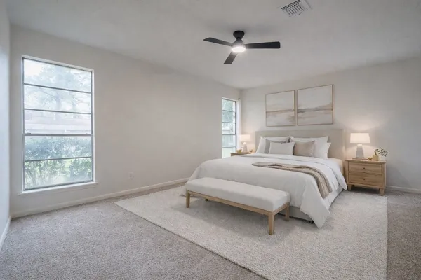 a bedroom with a bed and a window