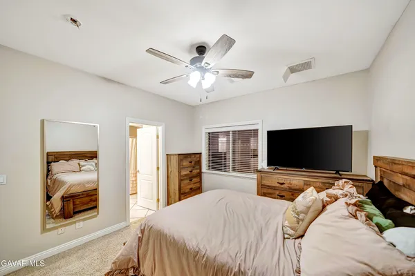 a room with a bed and a chandelier
