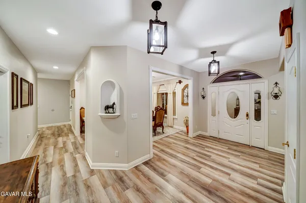 a living room with kitchen island furniture and a view of kitchen