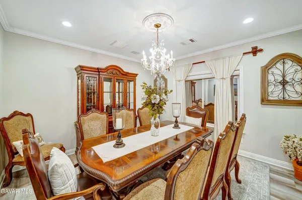 a large kitchen with stainless steel appliances granite countertop a stove a sink a refrigerator white cabinets and a granite counter tops