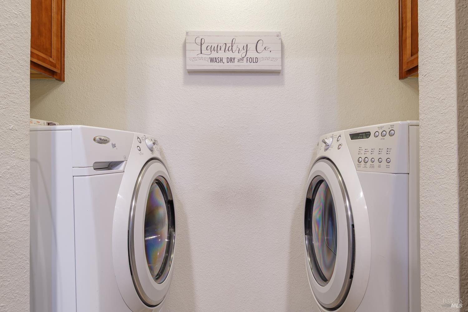 8201 Camino Colegio, Unit 123 Rohnert Park, CA 94928 - Photo 11 of 21 Kraftmaid wood storage cabinets in laundry space. Washer and Dryer included.