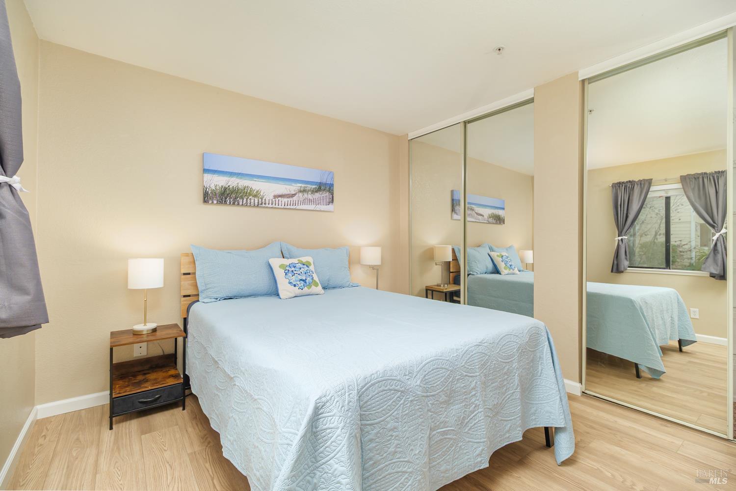 8201 Camino Colegio, Unit 123 Rohnert Park, CA 94928 - Photo 12 of 21 Primary Bedroom with two large mirrored closets and built-in closet organizers.