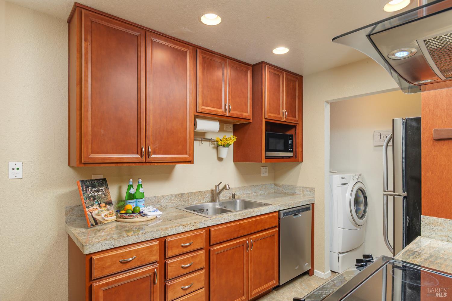8201 Camino Colegio, Unit 123 Rohnert Park, CA 94928 - Photo 8 of 21 Kraftmaid wood cabinets, granite counter tops, stainless steel double sink, dishwasher, refrigerator and stove. Microwave included.