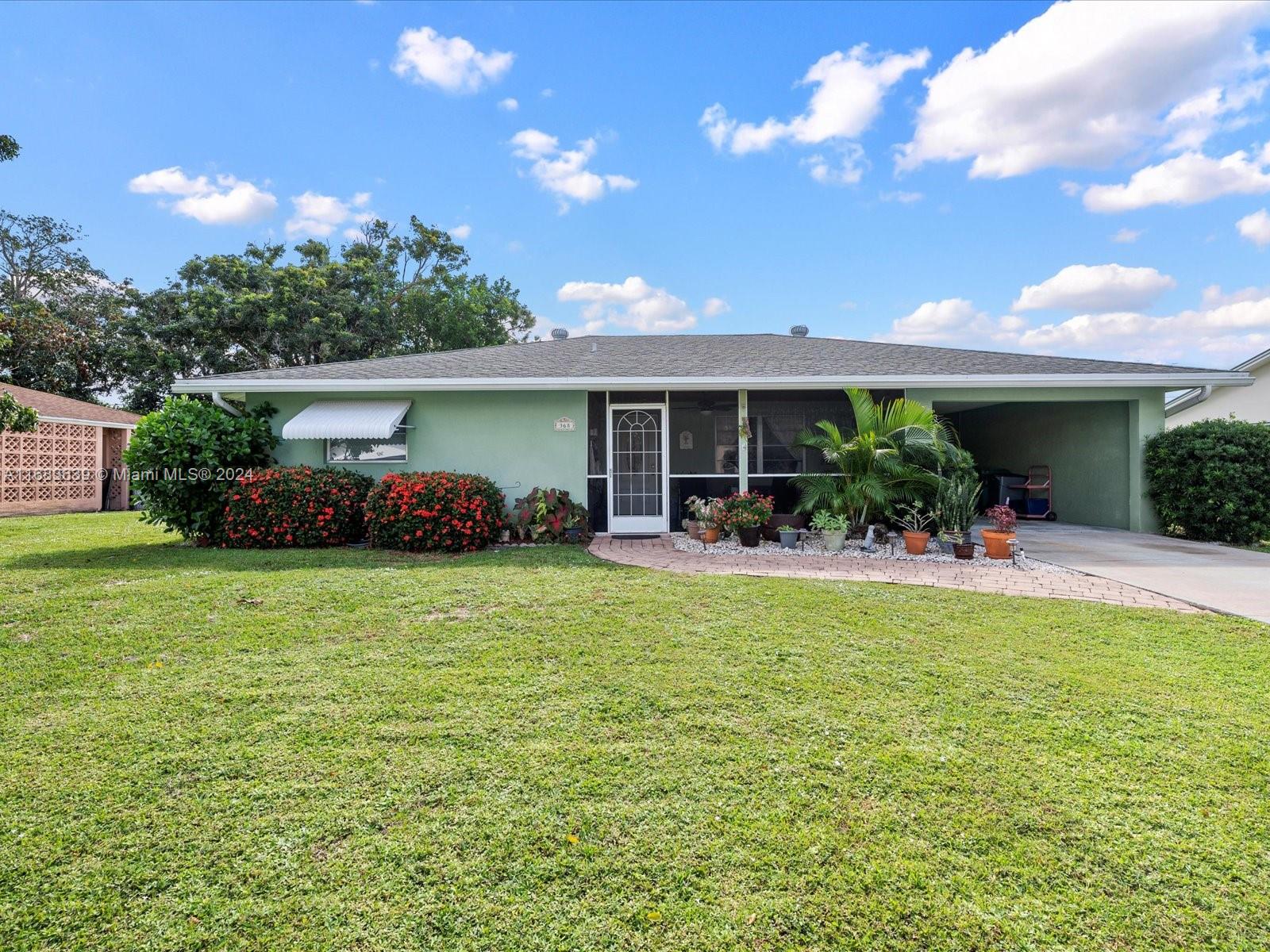 a front view of house with yard and outdoor seating