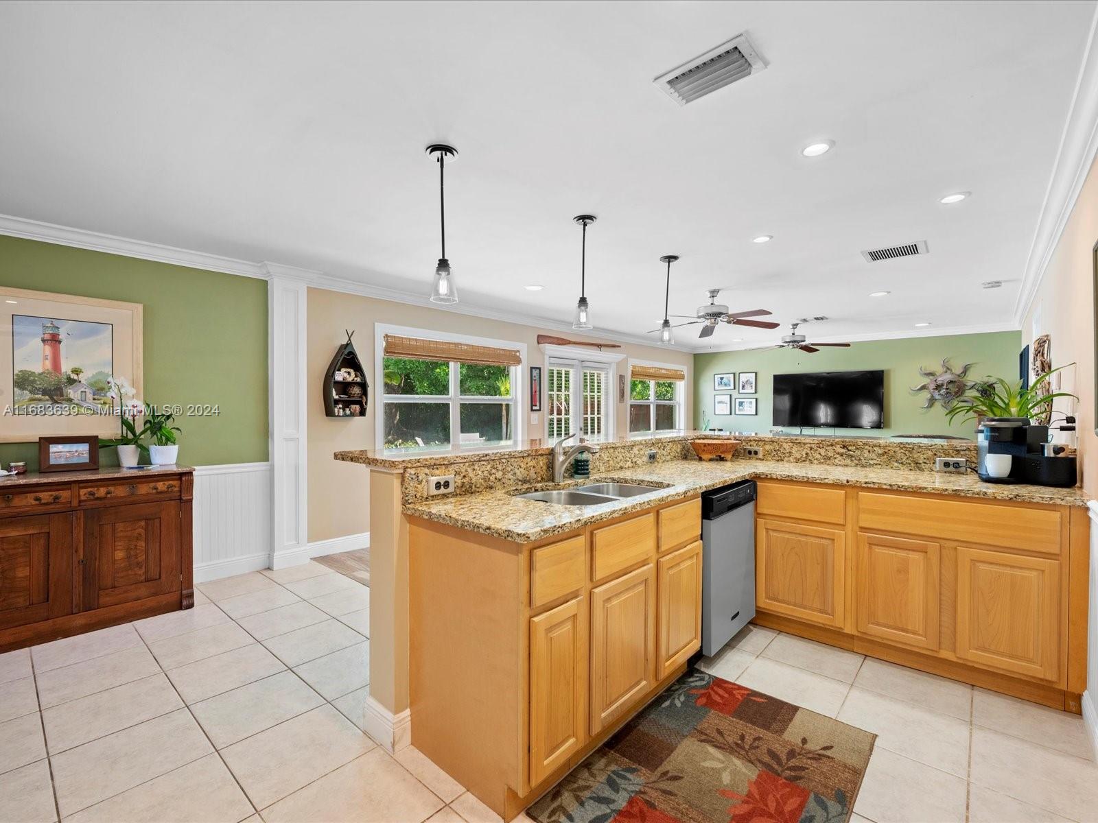 368 Church Road Tequesta, FL 33469 - Photo 11 of 20 a kitchen with a stove sink and cabinets