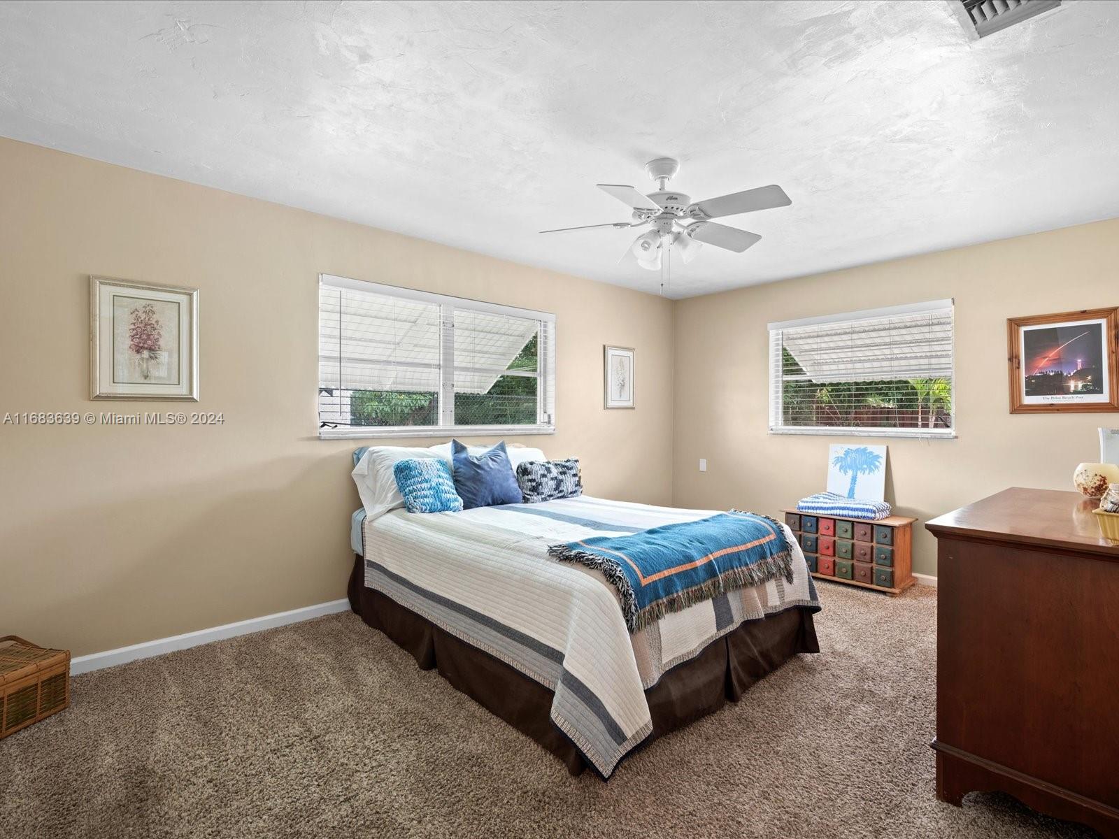 368 Church Road Tequesta, FL 33469 - Photo 15 of 20 a bedroom with a bed and a table in it