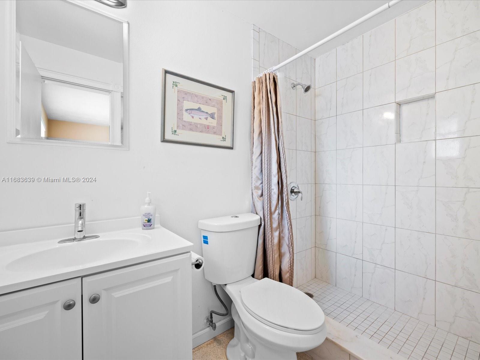 368 Church Road Tequesta, FL 33469 - Photo 16 of 20 a bathroom with a sink toilet and shower