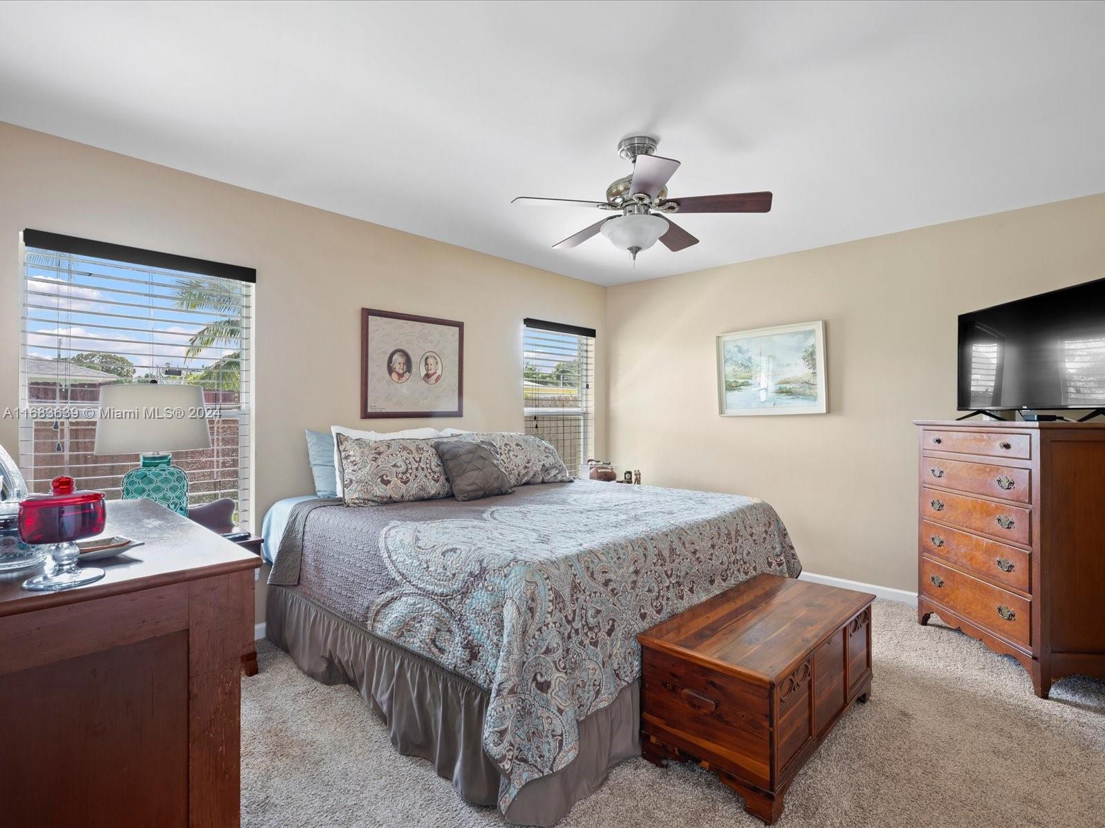 368 Church Road Tequesta, FL 33469 - Photo 17 of 20 a bedroom with a bed a dresser and a couch