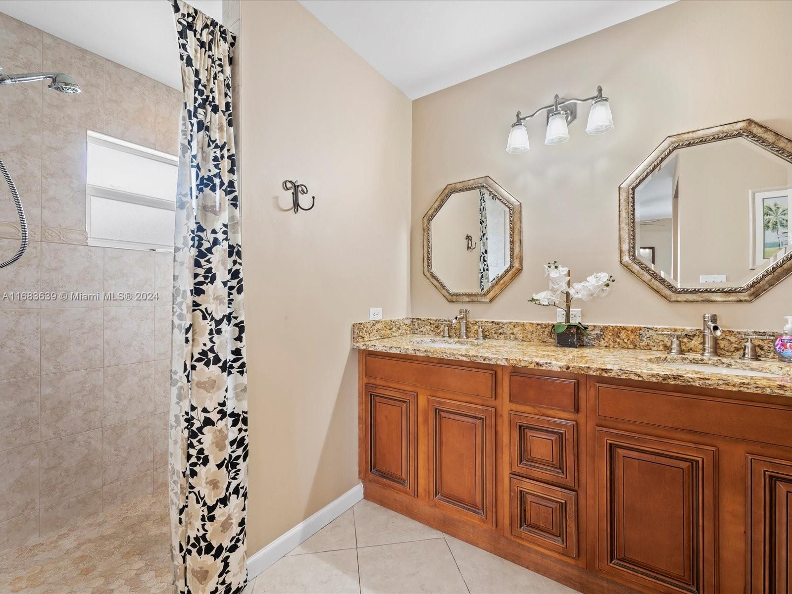 368 Church Road Tequesta, FL 33469 - Photo 19 of 20 a bathroom with a double vanity sink mirror and
