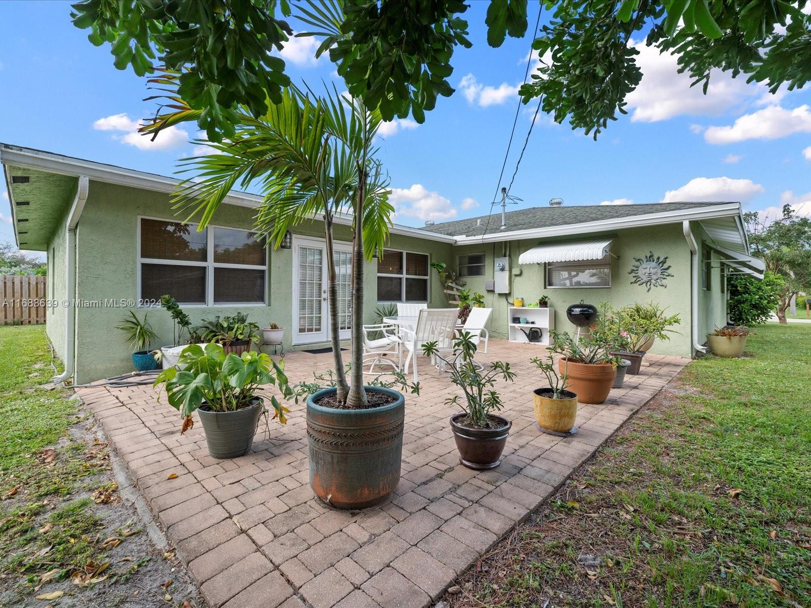 368 Church Road Tequesta, FL 33469 - Photo 3 of 20 a view of a porch with furniture and a potted plant