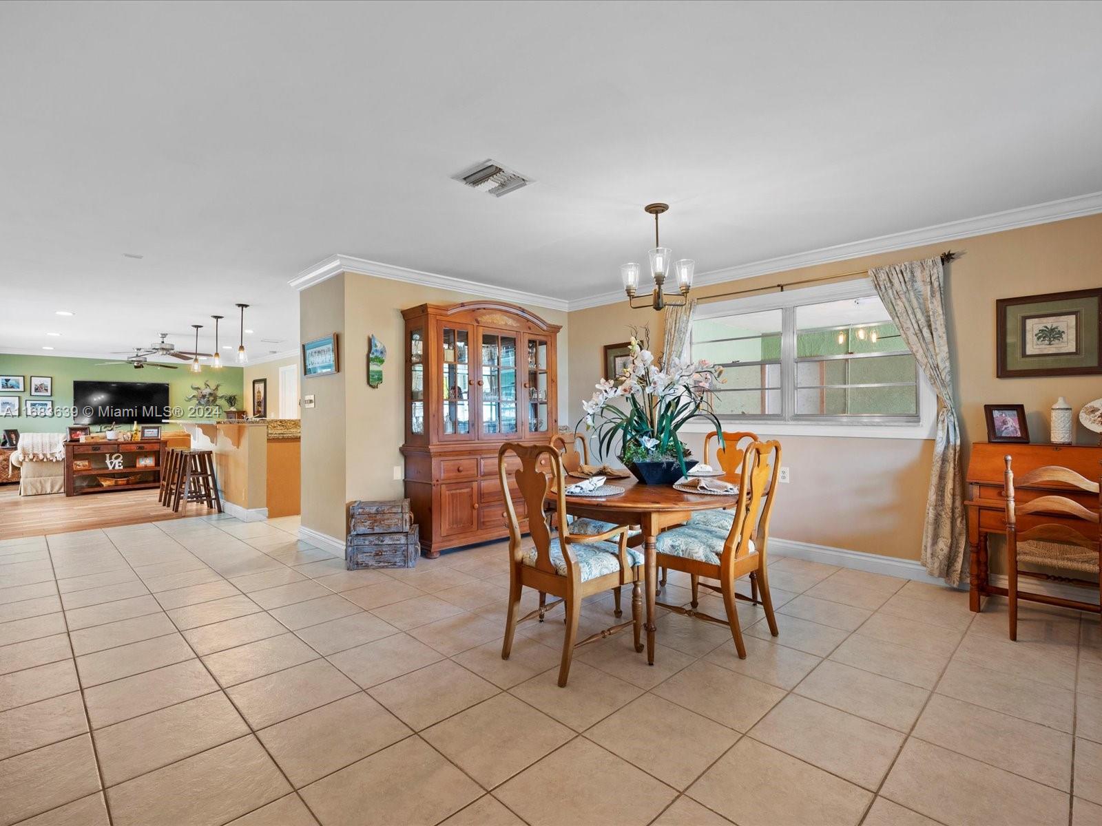 368 Church Road Tequesta, FL 33469 - Photo 5 of 20 a dining room filled with furniture and a livingroom