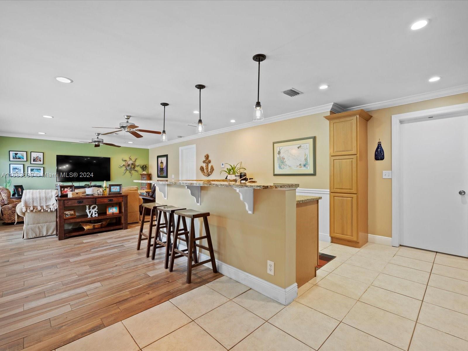 368 Church Road Tequesta, FL 33469 - Photo 7 of 20 a view of a kitchen with furniture and refrigerator