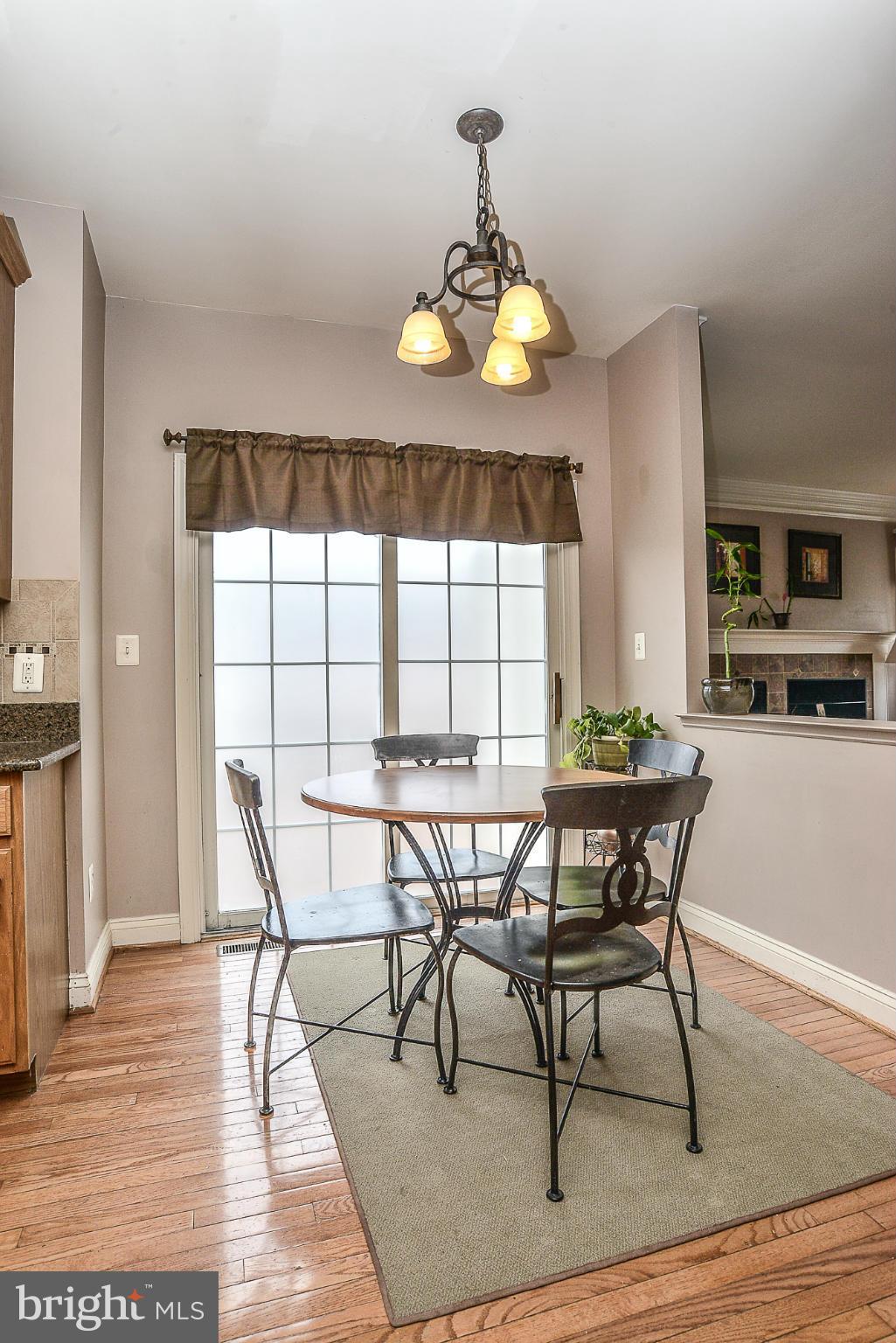 8747 Center Road Springfield, VA 22152 - Photo 13 of 30 a view of a dining room with furniture window and wooden floor