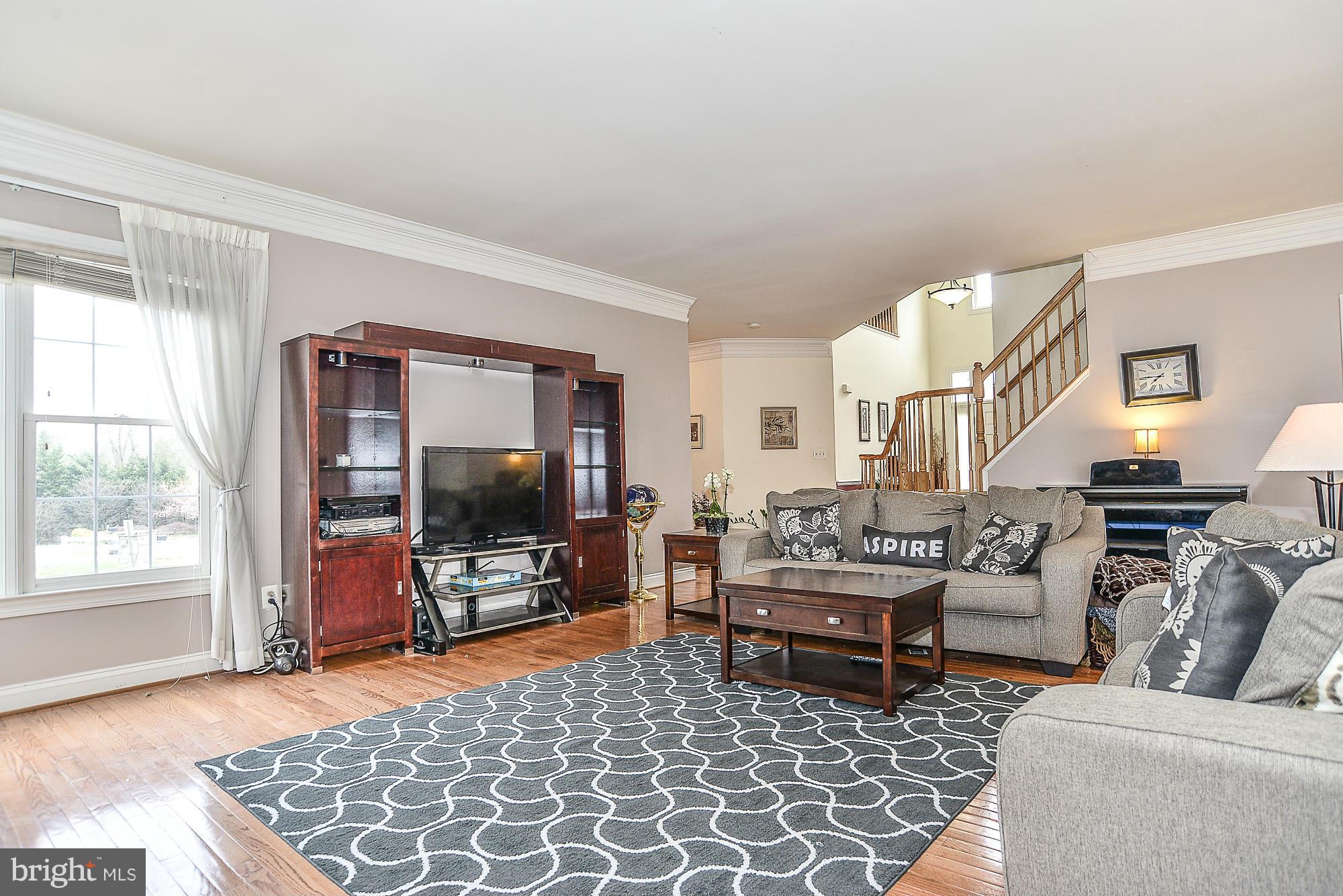 8747 Center Road Springfield, VA 22152 - Photo 15 of 30 a living room with furniture and a flat screen tv