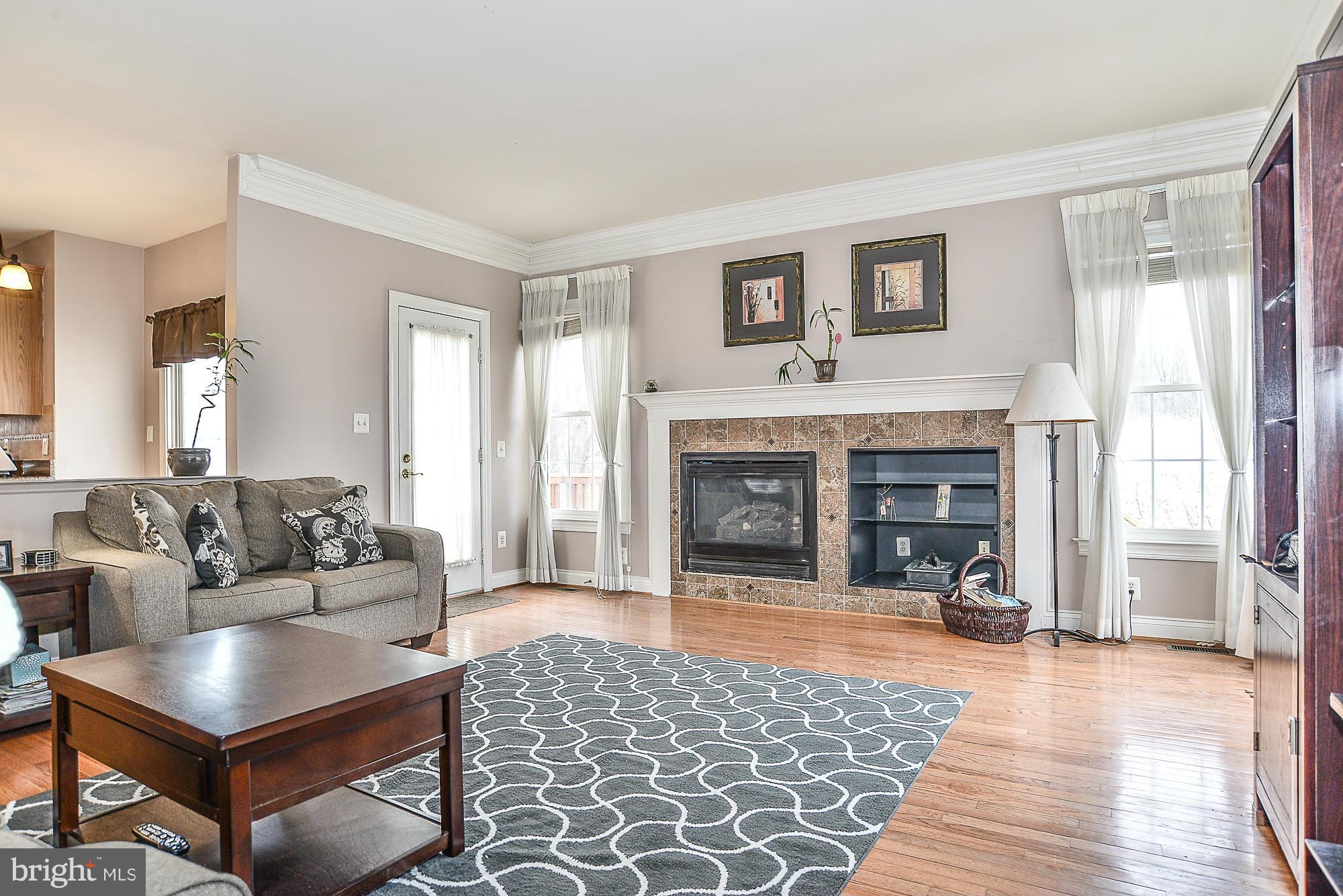 8747 Center Road Springfield, VA 22152 - Photo 16 of 30 a living room with furniture and a fireplace