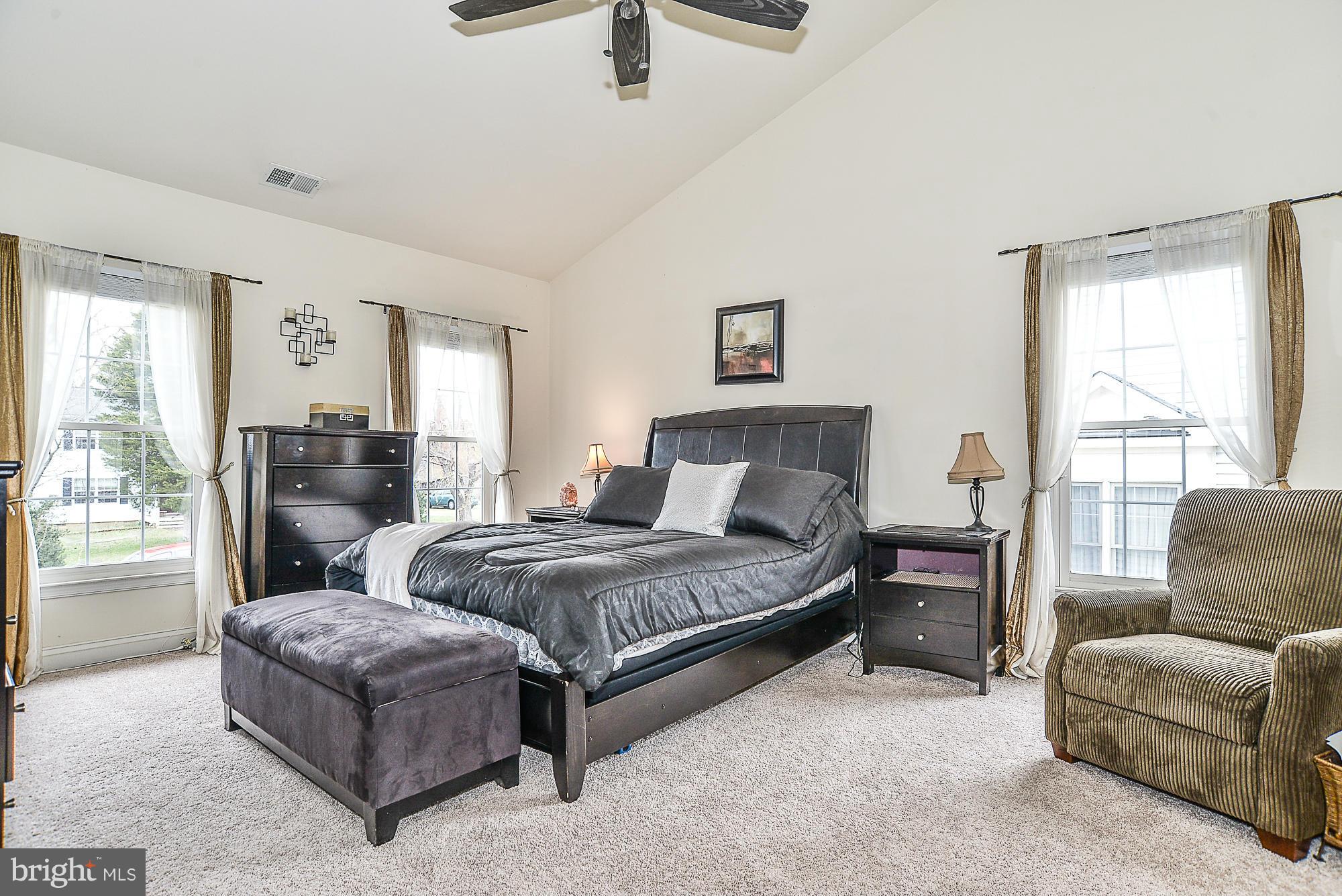 8747 Center Road Springfield, VA 22152 - Photo 18 of 30 a spacious bedroom with a bed and glass window