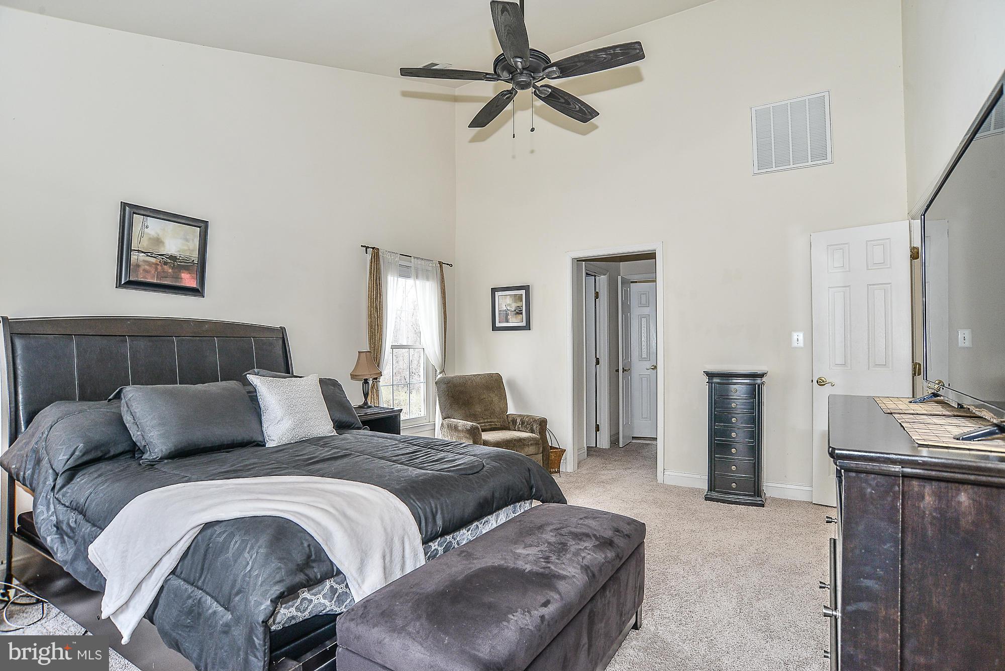 8747 Center Road Springfield, VA 22152 - Photo 19 of 30 a bedroom with furniture and a chandelier