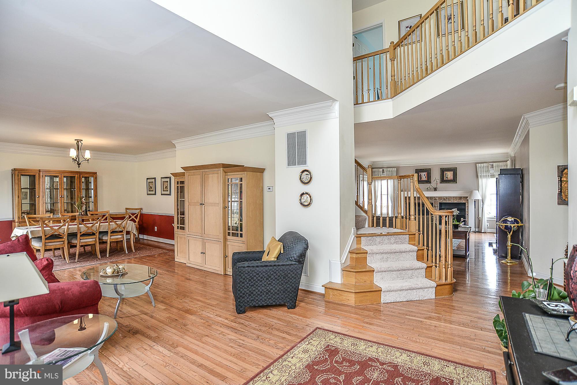 8747 Center Road Springfield, VA 22152 - Photo 3 of 30 a living room with furniture lots of wooden furniture and a view of kitchen