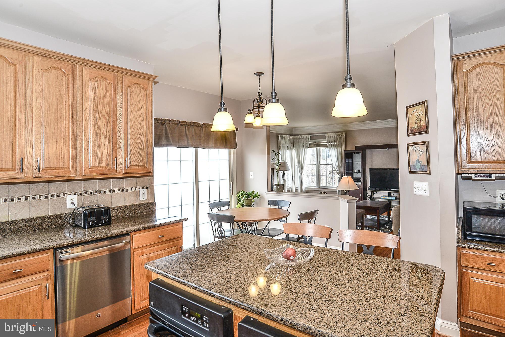 8747 Center Road Springfield, VA 22152 - Photo 10 of 30 a kitchen with stainless steel appliances granite countertop a stove a sink and a refrigerator
