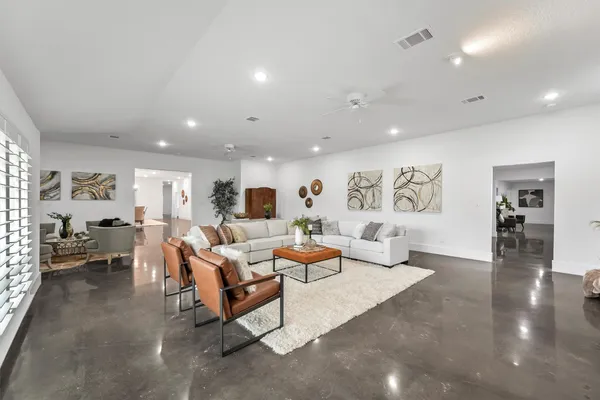a living room with furniture and wooden floor