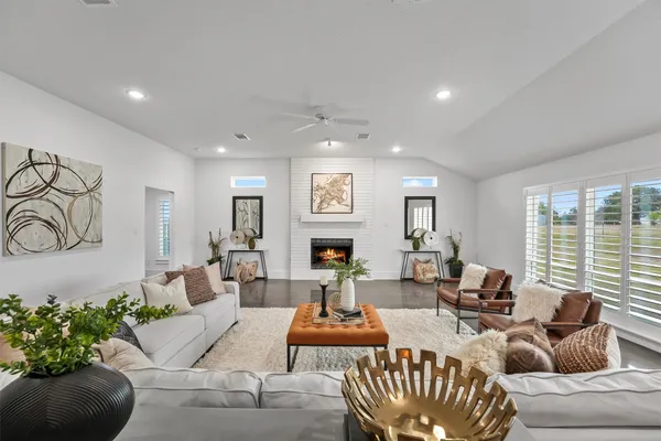 a living room with furniture fireplace and window