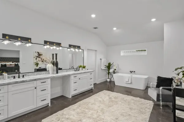a spacious bathroom with a double vanity sink mirror and shower