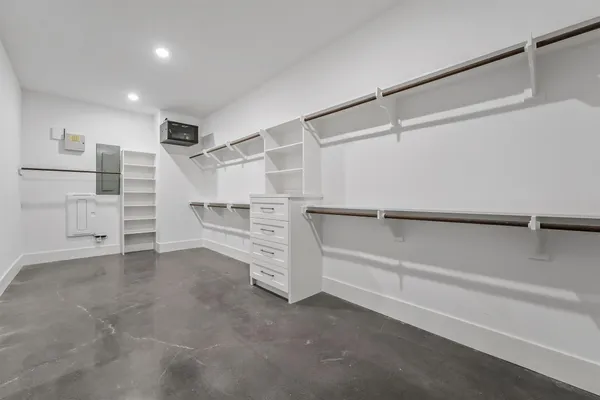 an empty room with a ceiling fan and closet area