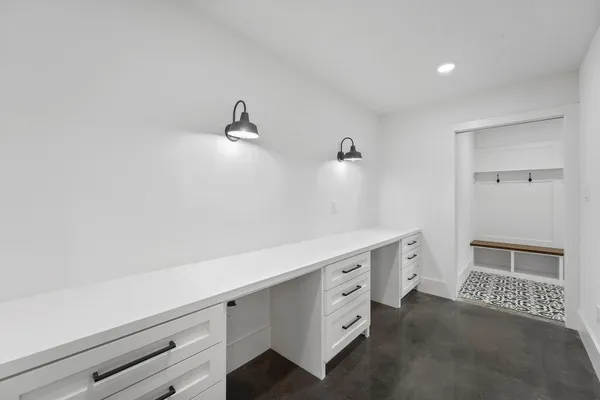 a room with a walk in closet and mirror