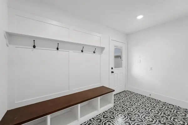 an empty room with windows and ceiling fan