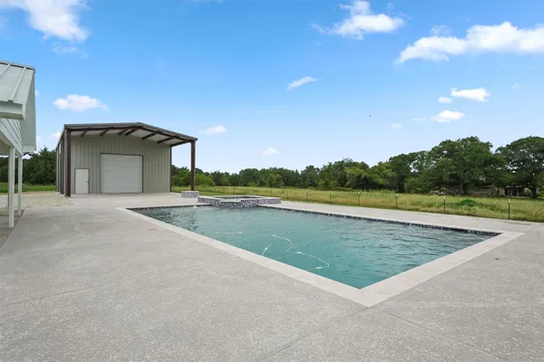 a view of an house with swimming pool outdoor seating