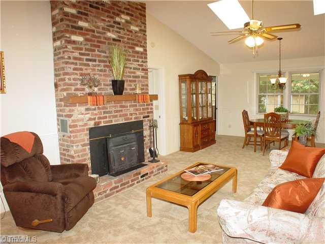 Living Room. Open Spacious Room with vaulted ceiling and fireplace allows a view to the front yard and back yard.