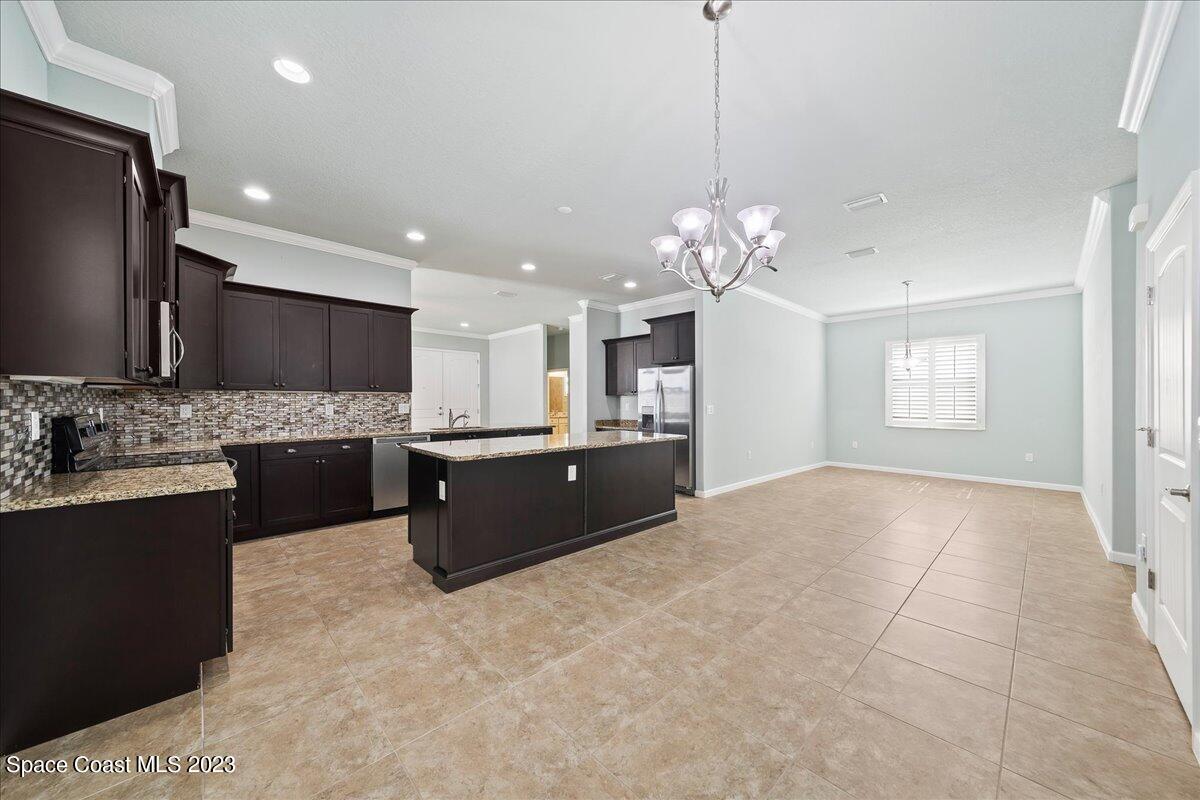 603 Heming Way Melbourne, FL 32901 - Photo 17 of 45 a large kitchen with kitchen island a sink stainless steel appliances and cabinets