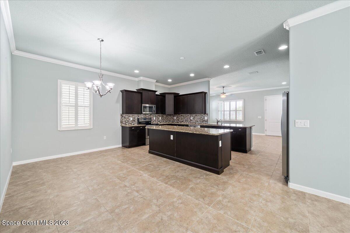603 Heming Way Melbourne, FL 32901 - Photo 20 of 45 a large kitchen with a large counter top a sink stainless steel appliances and cabinets