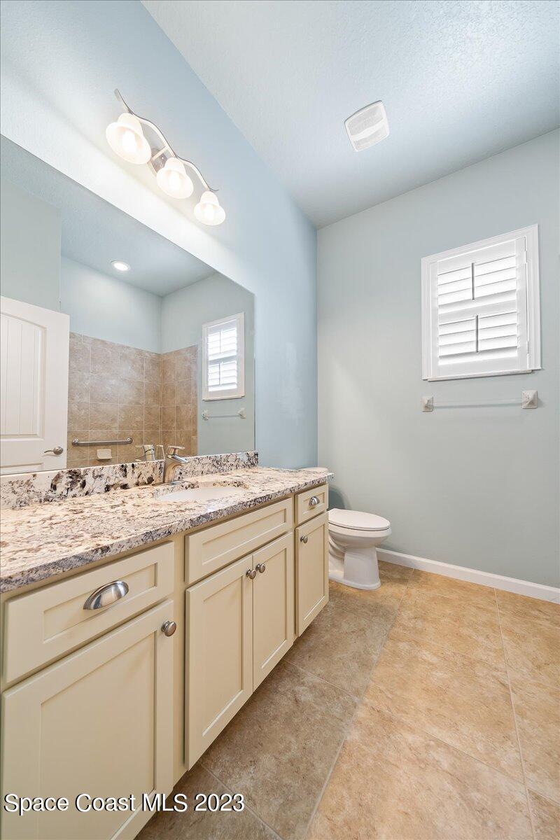 603 Heming Way Melbourne, FL 32901 - Photo 34 of 45 a bathroom with a toilet sink and mirror