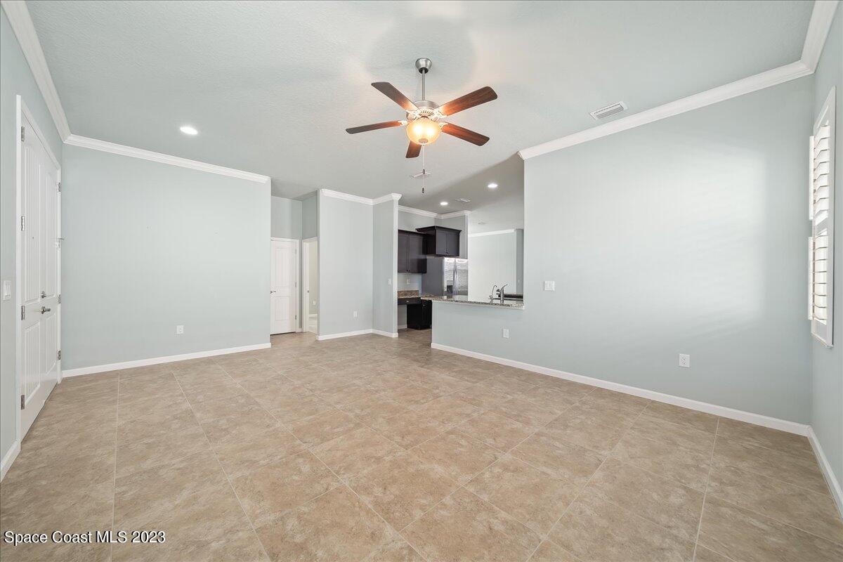 603 Heming Way Melbourne, FL 32901 - Photo 10 of 45 an empty room with a ceiling fan and a window