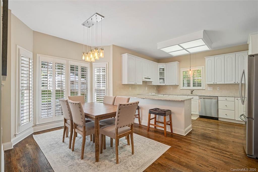 7915 Park Road Charlotte, NC 28210 - Photo 11 of 40 a view of a dining room with furniture window and wooden floor