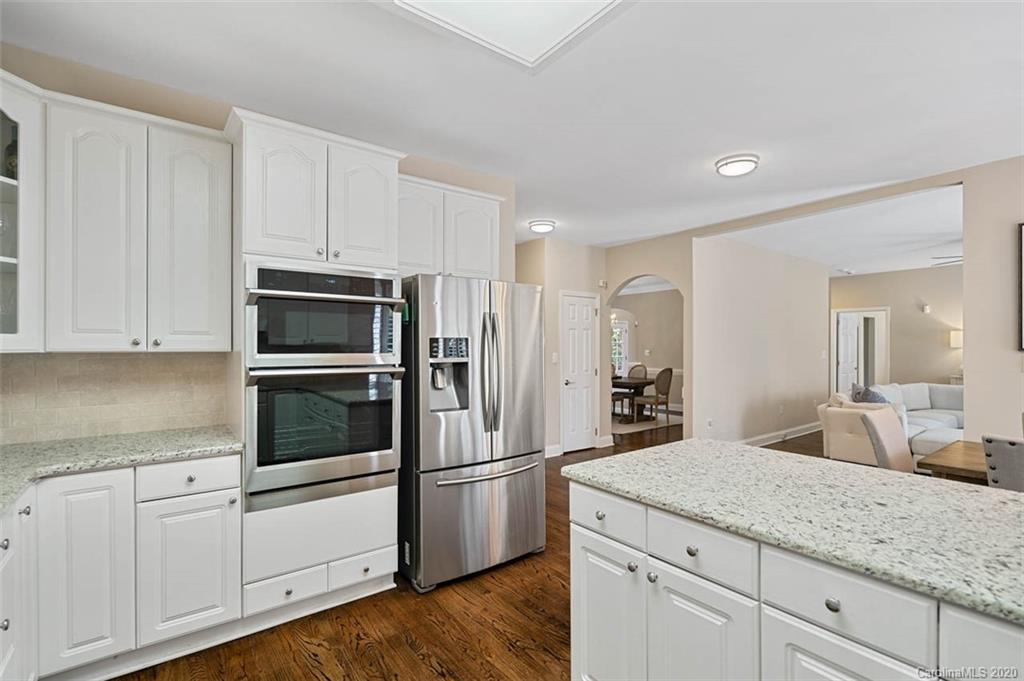 7915 Park Road Charlotte, NC 28210 - Photo 14 of 40 a kitchen with granite countertop white cabinets and stainless steel appliances