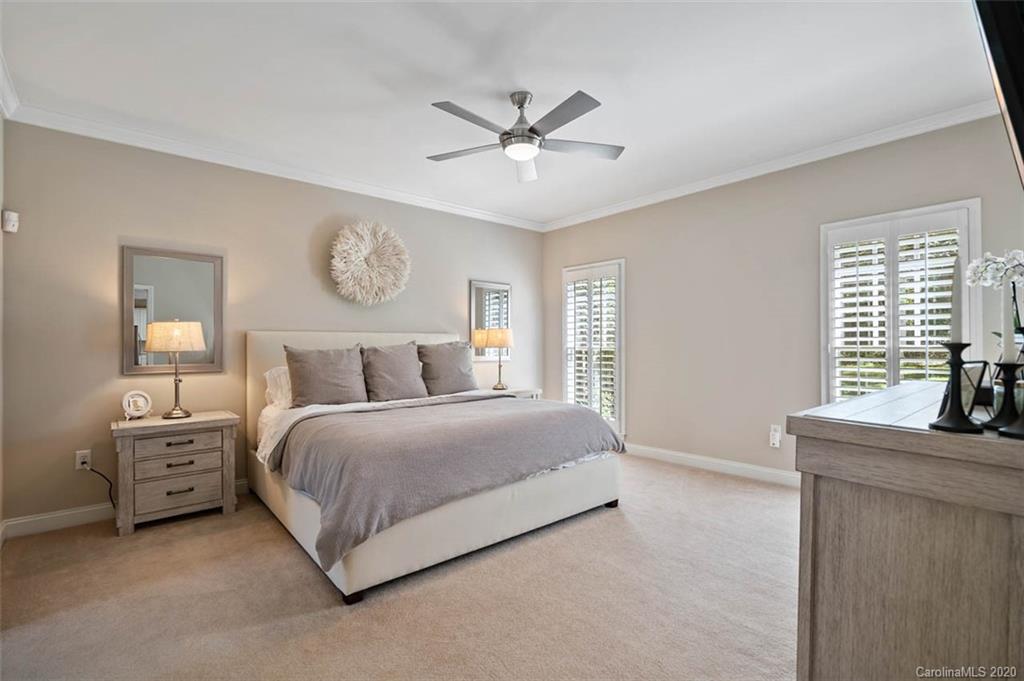 7915 Park Road Charlotte, NC 28210 - Photo 15 of 40 a bedroom with a bed and a chandelier