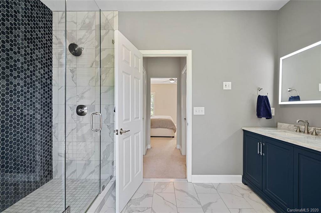 7915 Park Road Charlotte, NC 28210 - Photo 16 of 40 a bathroom with a shower sink and mirror